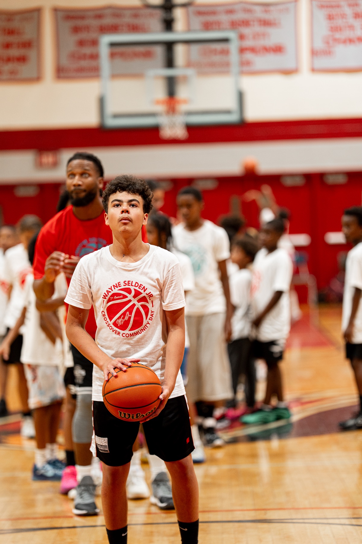 Young participant preparing to shoot during a WSJ Crossover athletics clinic
